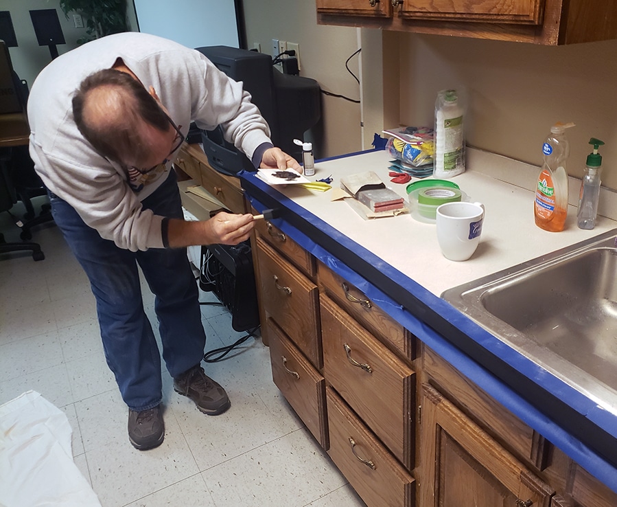 Person helping to make repairs to the library meeting room